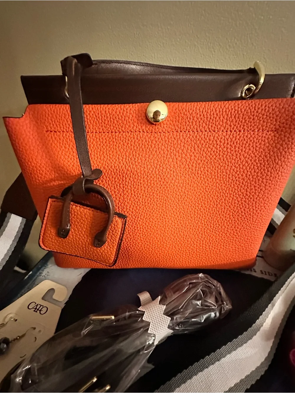 Orange hand Bag with Dark Brown Trim two crossbody straps..filled